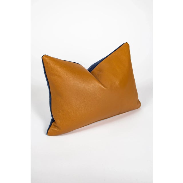 This creamy brown leather is paired with a soft blue felt fabric to make a luxurious addition to any room in your home....