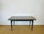An elegant rectangular table in the Art Deco modernist style of the 1940s-50s, featuring a superb exotic wood veneer top...