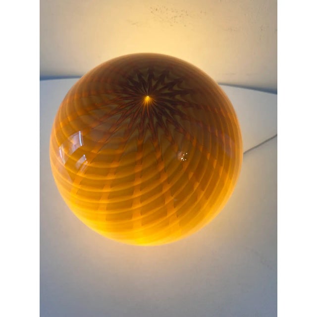 Impressive contemporary amber sphere swirl working in murano glass design in very particular and effective movement. In...
