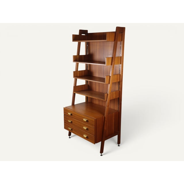 An elegant vintage bookcase from the 1960s, characterized by an asymmetrical silhouette inspired by Scandinavian and...