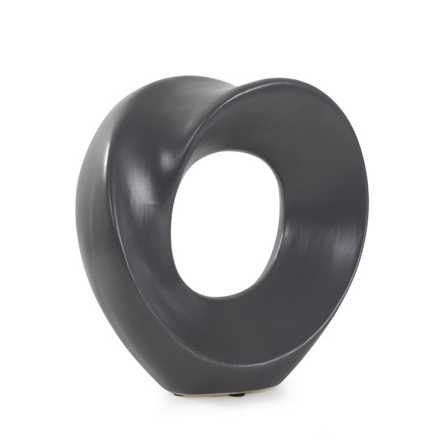 A captivating piece in matte charcoal gray. This sculpture is simple yet mesmerizing with a twist that creates the...