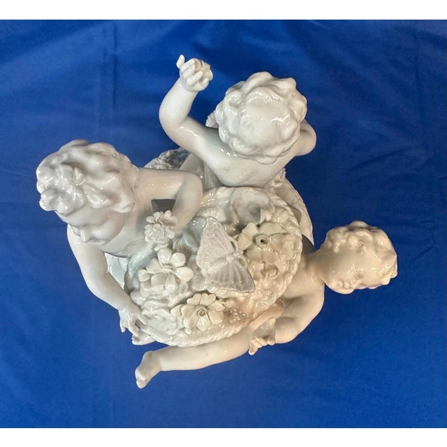 This 19th century Continental figural group of children is beautifully rendered in wihite porcelain with a high gloss...
