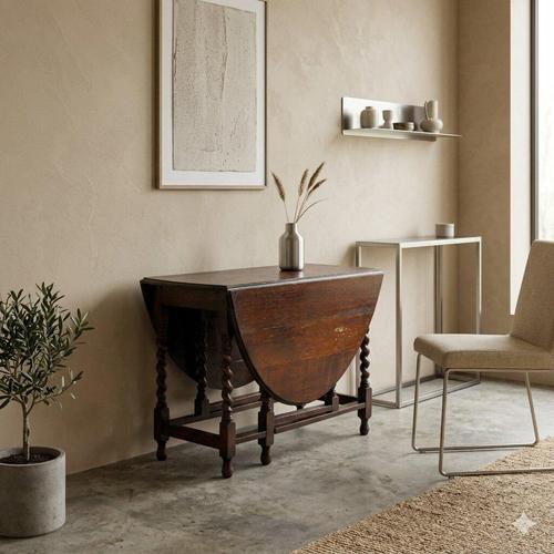 Walnut-stained oak table with hinges. The top rests on six turned and carved twisted legs, two of which open to support...