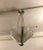 French Art Deco chandelier signed by Atelier Petitot. The three shades are in clear frosted glass with over flowing...
