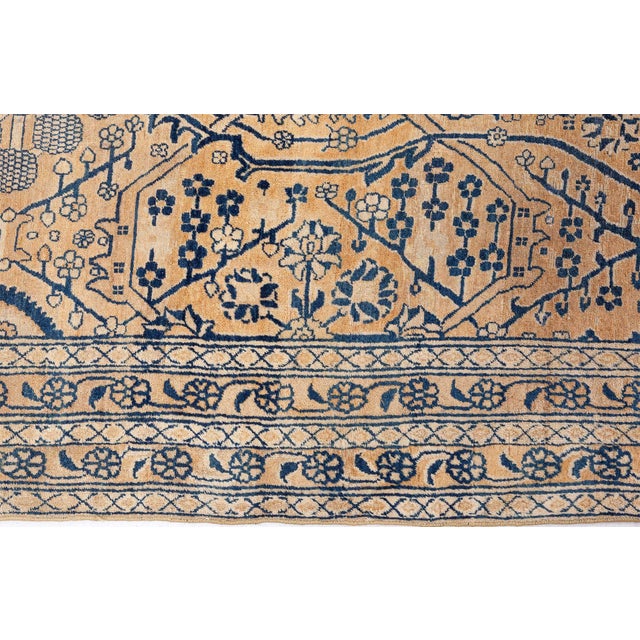 A fine example from our collection of late 19th century Persian Kerman rug, the golden yellow field with a delicately-...