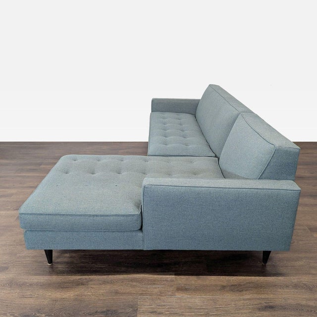 This Room and Board sectional offers a clean, modern look in a versatile blue fabric. The sofa features comfortable...
