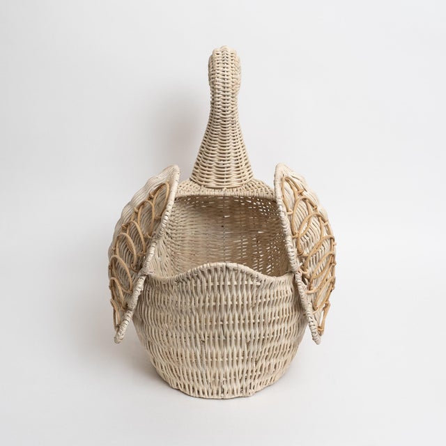 Beautiful Lucite Provence rattan swan basket, handcrafted in whitewashed woven rattan over a lucite frame. This charming...