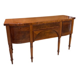 1900 - 1909 Regency/Federal Figured Mahogany Sideboard With Bowed Ends, Turned Legs, and the Distinctive Arched Center Panel. For Sale