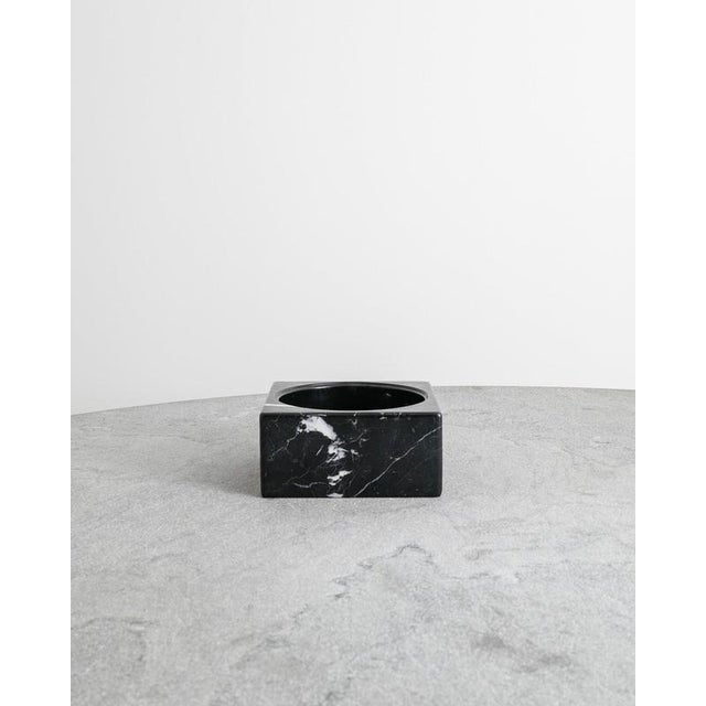 A rare and iconic "pk-bowl" ashtray in solid black marble by poul kjærholm and produced in denmark and a limited serie in...
