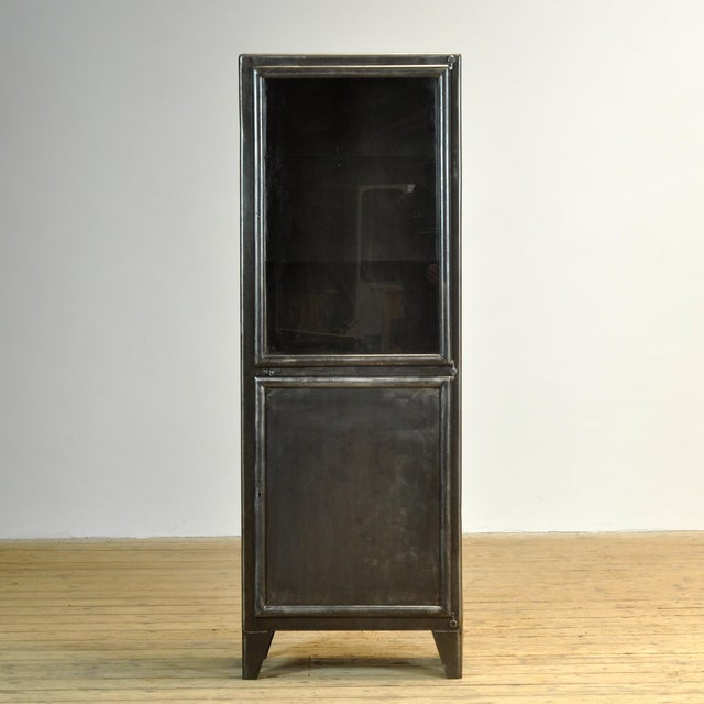 Medical cabinet from the 1950s, manufactured by Kovona. This cabinet is made of iron and glass, creating a rugged...