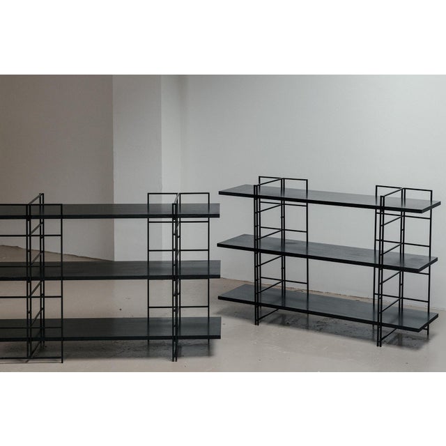 Postmodern shelving units manufactured in Germany around 1980. The units feature a black lacquered steel frame, which you...