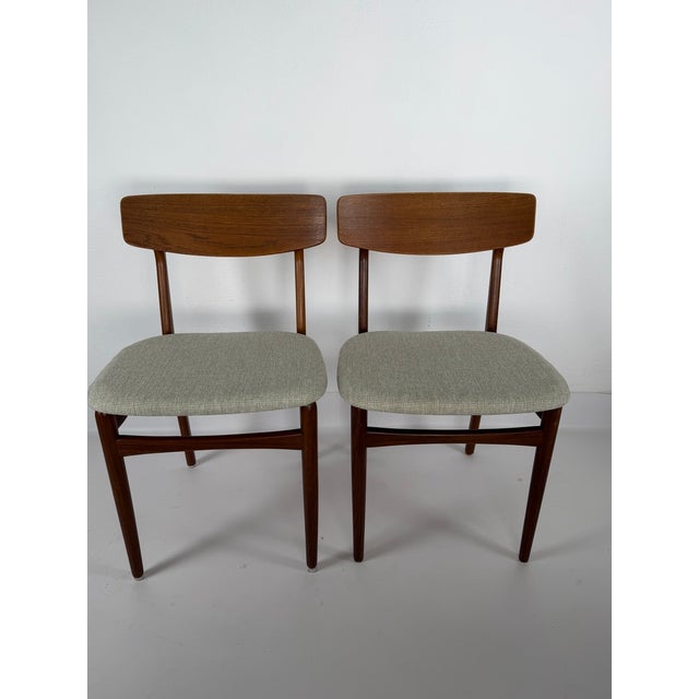 Elegant pair of Danish dining chairs from the 1960s, crafted from teak and featuring a light, timeless form characteristic...