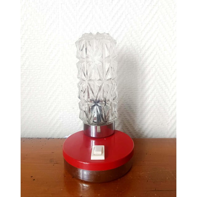 Night light, space age style, circa 1970 Small table lamp with a round, silver and red steel base and a cylindrical molded...