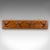 This is an antique coat rack. An English, mahogany and steel cloakroom or reception hall quartet of mounted hooks, dating...