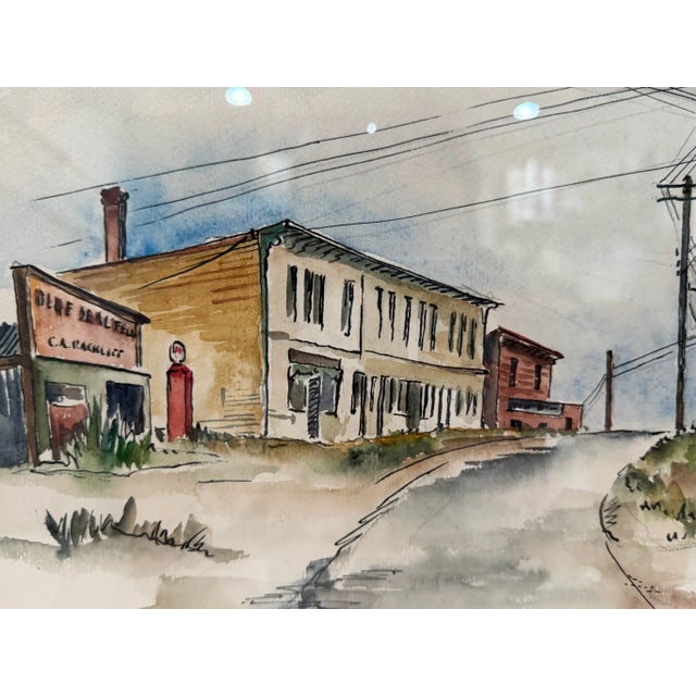Original 1952 watercolor by Emil Heinz, depicting a quiet mid-century American street lined with weathered storefronts and...