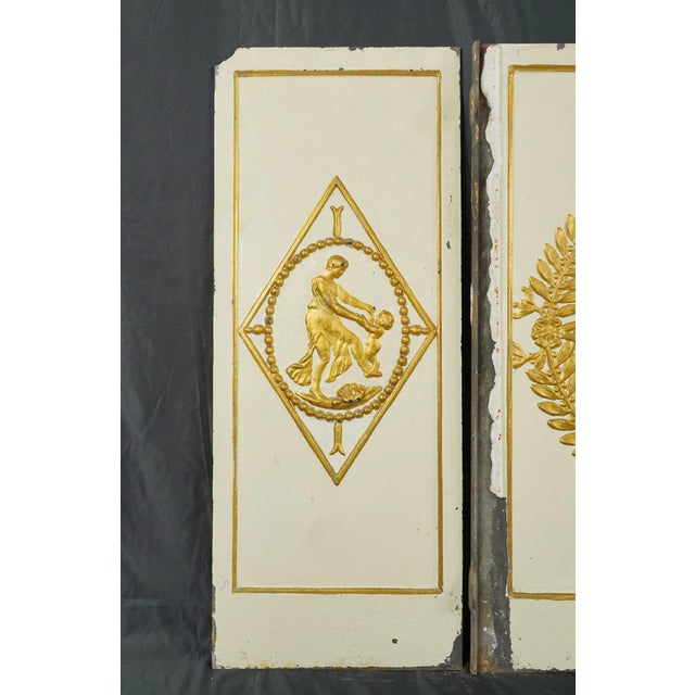 French style fireback panels made of painted white cast iron, with a gilded raised figural design. This set is original to...