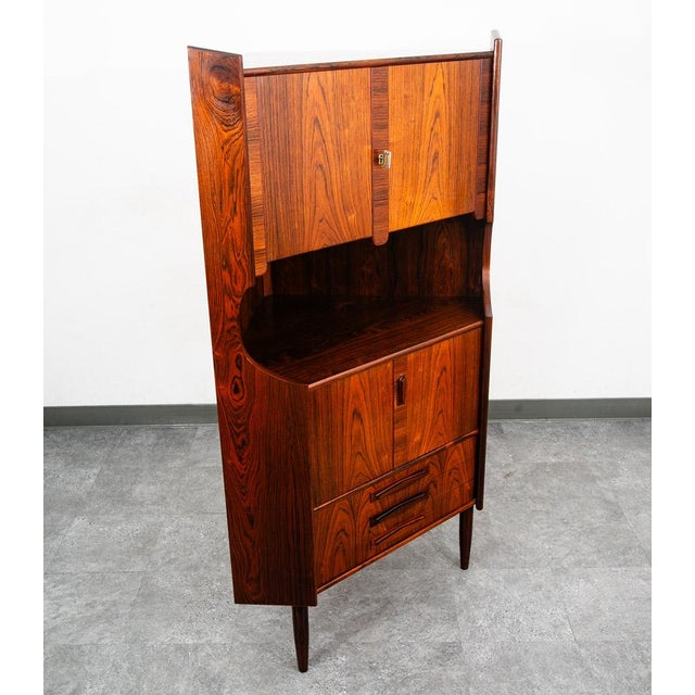 Outstanding Danish rosewood corner cabinet designed in Denmark, circa 1960s. Features three drawers, an open storage space...