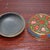 This charming vintage Chinese circular lacquer lidded box features deeply carved raised relief decorated with traditional...