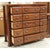 This piece features a warm brown wood finish with fifteen drawers arranged in a clean, grid‑like layout. Each drawer is...