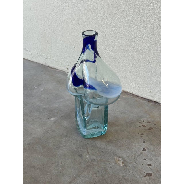 A striking mid-century hand-blown art glass vase, featuring a sculptural organic form with a bubble-like mid-section...