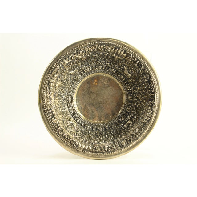 An impressive hand tooled bowl Made of low grade silver, lavishly hand decorated with floral and zoomorphic repousse...
