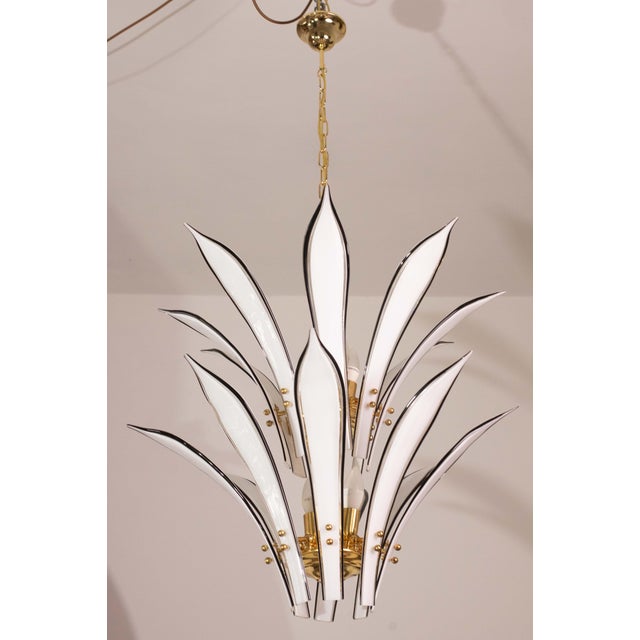 Murano glass chandelier with beautiful palm-shaped leaves in white with black border. The palms are developed in two...
