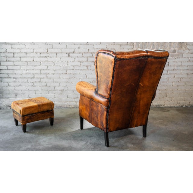 1970s Vintage Art Deco Distressed Cognac Leather Wingback Chair & Ottoman For Sale - Image 11 of 16