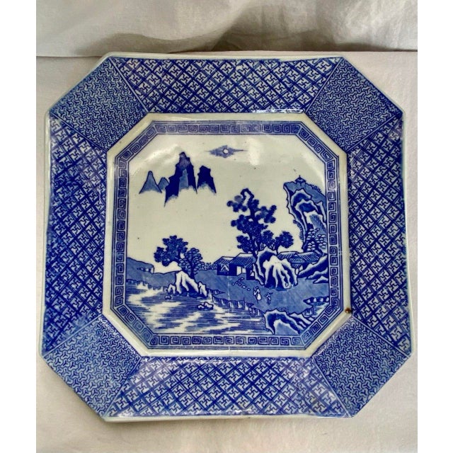 Graceful in both form and decoration, this antique Chinese octagonal porcelain serving plate presents a tranquil blue-and-...