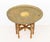 Persian Brass Tray Top Folding Wood Table, the charged with stamped geometric designs. Overall: 19" H x 25" Diameter....
