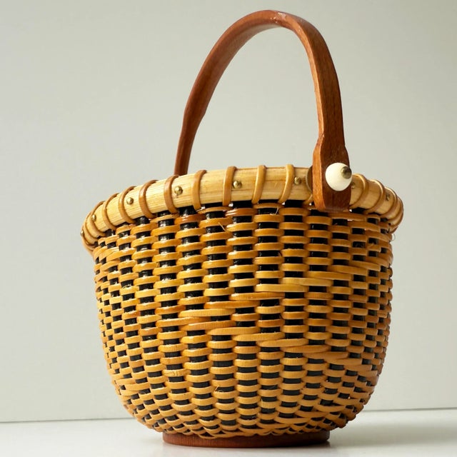 This beautifully handcrafted vintage Nantucket Lightship Basket is a signed piece, marked by the artisan on the underside....