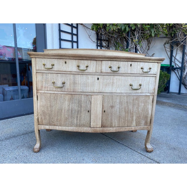 Beautiful solid wood cabinet with 3 drawers and two doors. Original brass hardware and accent back. New bleached finish...
