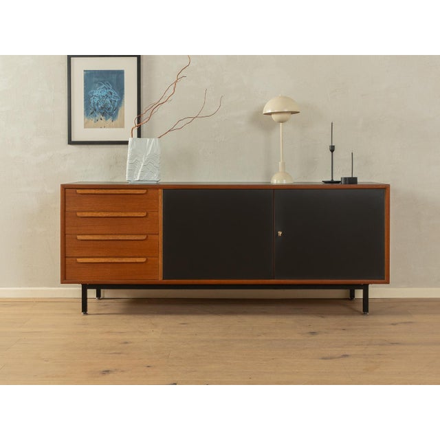 Unique sideboard from the 1960s in Scandinavian design. High-quality body in teak veneer with four drawers, two Formica-...
