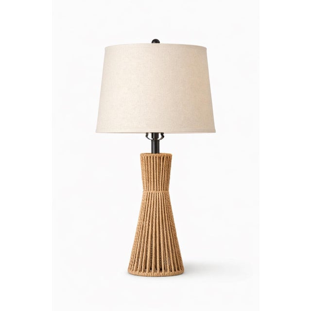 A sculptural pair of cord-wrapped table lamps with tailored linen drum shades, offering warm texture and quiet...
