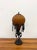 An exceptional Maitland-Smith table lamp modeled after a vintage hot air balloon, featuring a richly textured amber art...