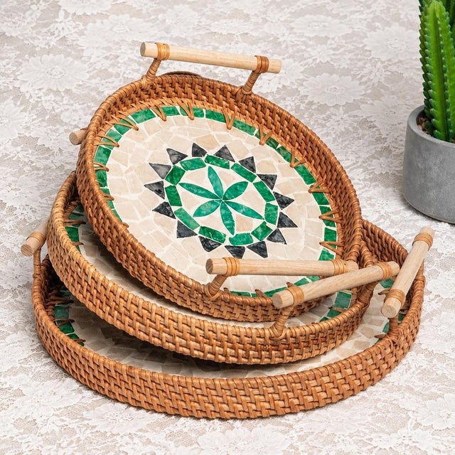 A set of three round trays with a hand-woven frame made of natural rattan. The surface of the tray is spliced ​​with...