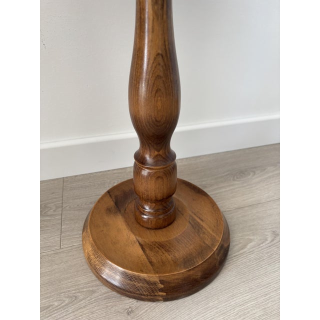 Charming little vintage wooden side table with an elegant and timeless silhouette. Its round top rests on a central turned...