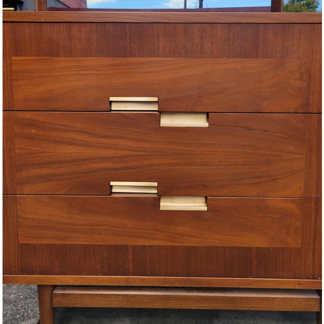 A walnut lowboy dresser and mirror in great original condition from Merton Gershun's iconic Accord collection for American...