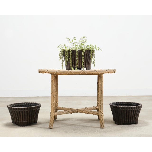An organic and subtle set of three Chinoiserie decorated bronze jardinières or planters crafted out of cast bronze metal....