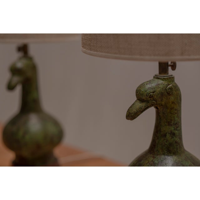 Elegant pair of French mid-century table lamps crafted in green patinated bronze, sculpted in the shape of stylised Asian-...
