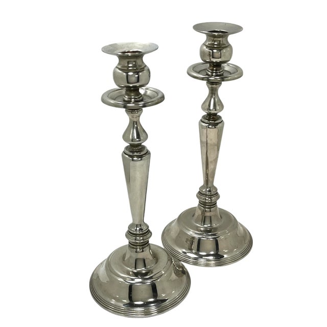 Add an elegant touch to your favorite table with this fine pair of silver plate neo-classical style candlesticks by...