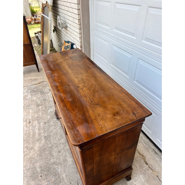 Crafted in France during the 19th century, this elegant Louis Philippe buffet features richly figured walnut with a warm,...