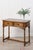 This oak side table features two paneled drawers with round wooden knobs for storage, while the beveled top showcases the...