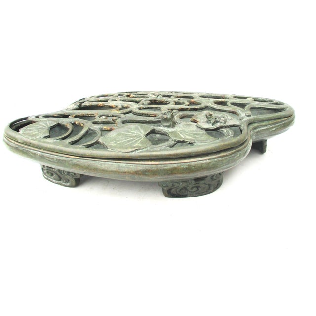 Japanese flower ikebana tray with elaborate top. Water motif swirling over the top with waterlilies and a frog on the lily...