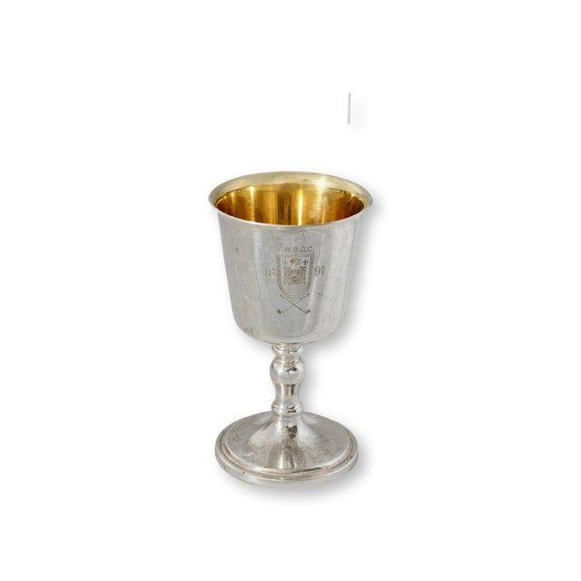 A charming English golf trophy dating to 1891, featuring a classic goblet form with a beautifully preserved gilt-washed...