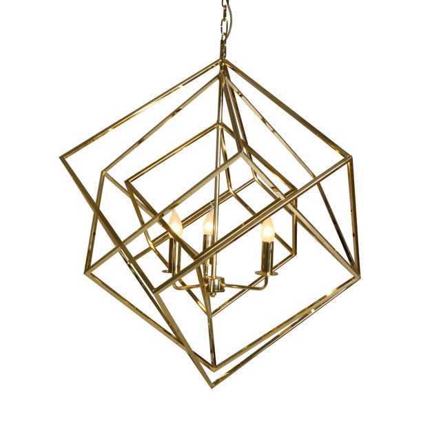Sculptural geometric chandelier crafted from polished brass in a striking open-frame composition of interlocking cubes,...