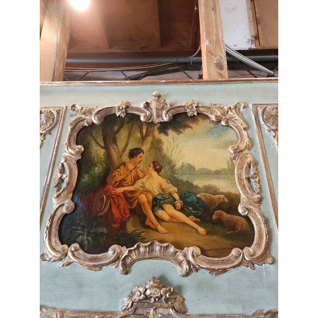 A striking mid-19th century French trumeau mantel mirror executed in the elegant Louis XV Rococo style. The upper panel...