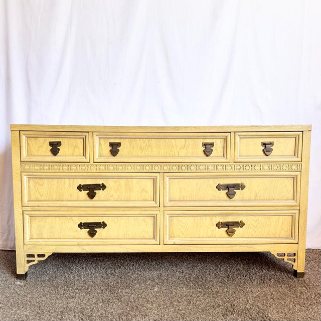 This vintage Chinoiserie “Shangrila” dresser by Dixie embodies the refined glamour of mid-century Hollywood Regency...