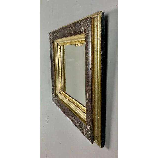 19th century English wood frame with mirror inset. The mirror is decorated with beautiful inlay designs throughout....