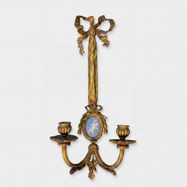 This is a pair of antique French Louis XVI style gilt bronze ribbon sconces with jasperware putti medallions. They are...
