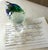Artisan glass dolphin paperweight showcases a playful nautical design with a vibrant blue and green dolphin perched atop a...